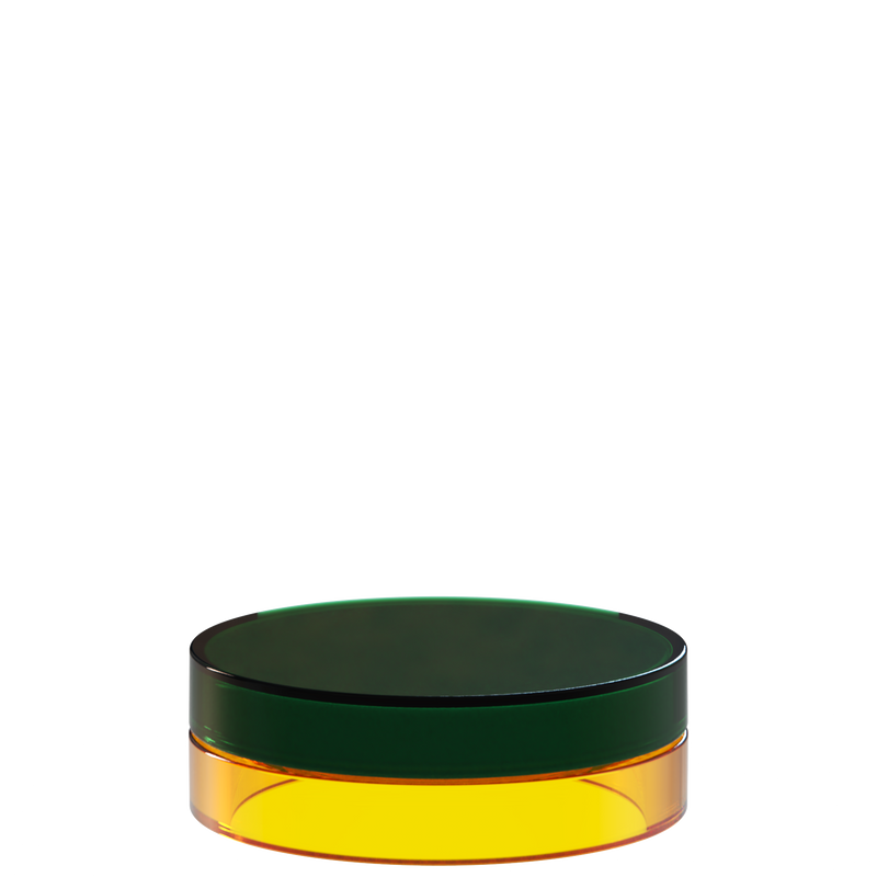 Sai 43 interchangeable cosmetic holder in dark green and amber, angled view of the flat cylinder